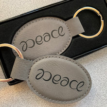 Load image into Gallery viewer, Peace ambigram keychain